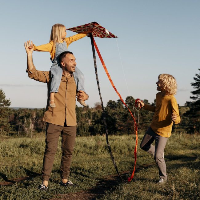 full-shot-family-playing-with-kite
